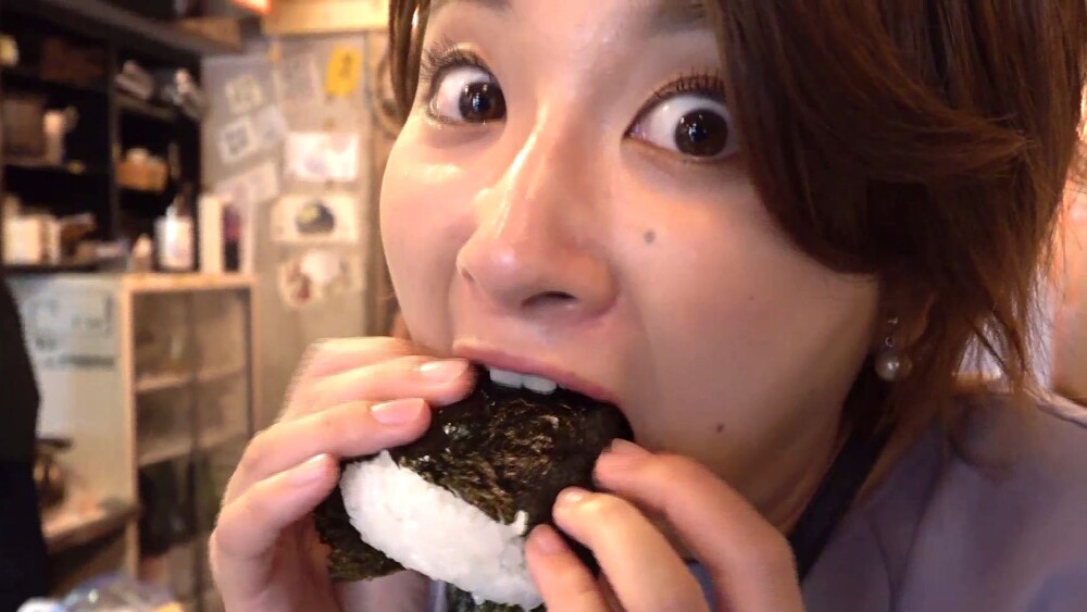 炊き立てご飯のおにぎりにかぶりつく